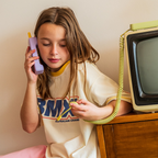 Young girl using Waffle Home screen-free kids phone handset, no apps no internet