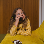 Young girl using Waffle Home screen-free kids phone at home, ages 5-12